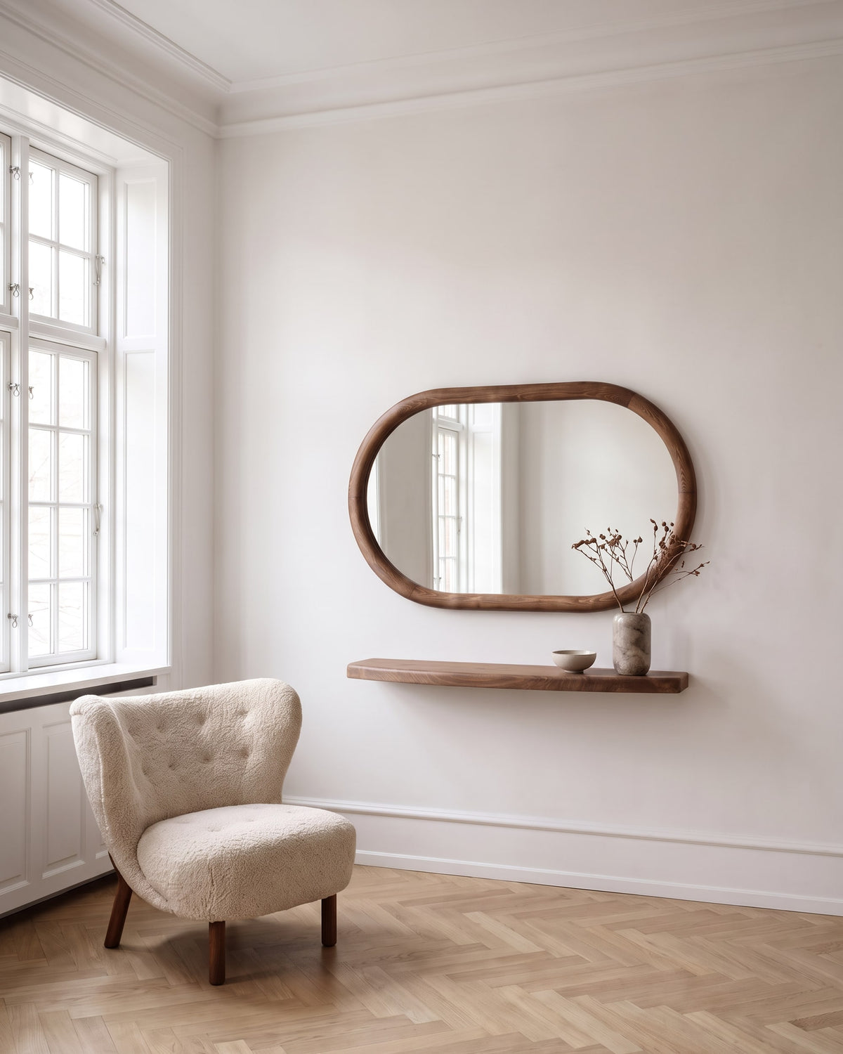 Livia oval mirror 110 × 70 cm with matching floating walnut-finish shelf in a bright living room