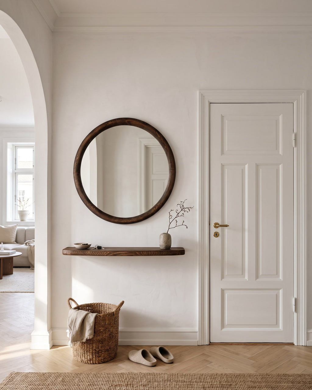 Mira round mirror Ø 85 cm with floating walnut shelf in an entrance hall, keys in a bowl, coat on hooks and an oak bench