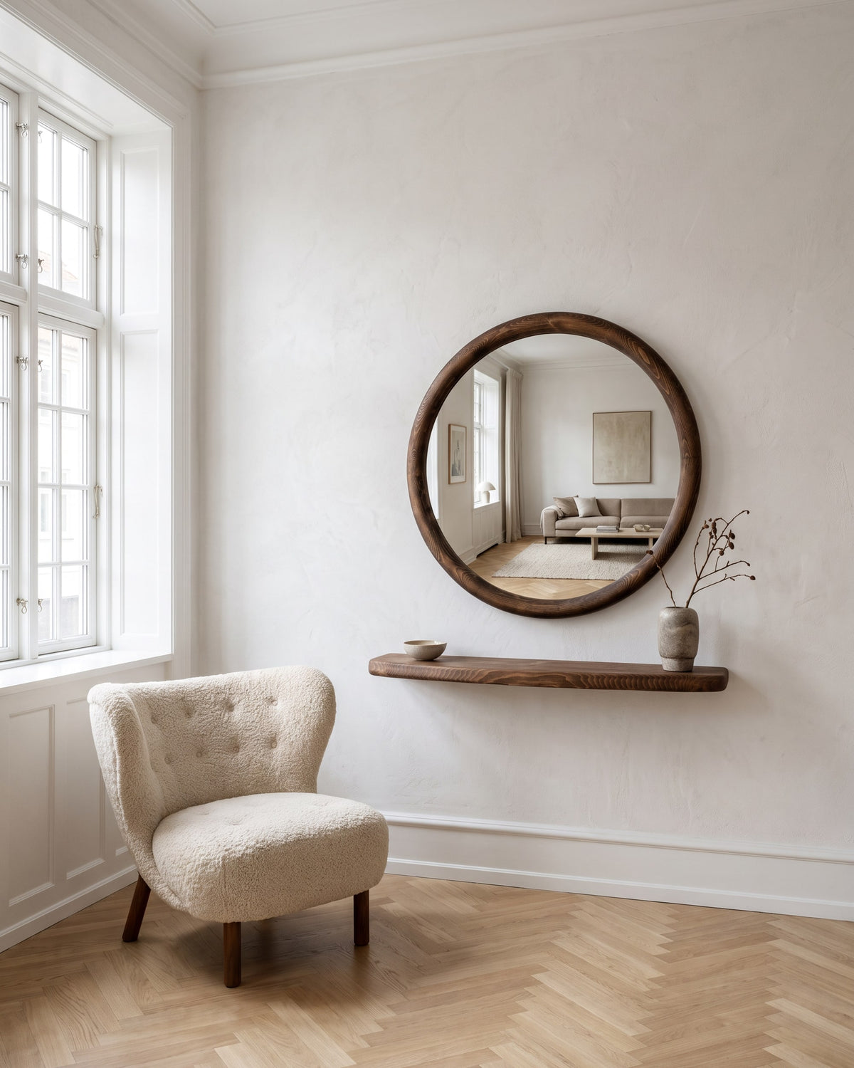 Mira round mirror Ø 85 cm with matching floating walnut-finish shelf in a bright living room