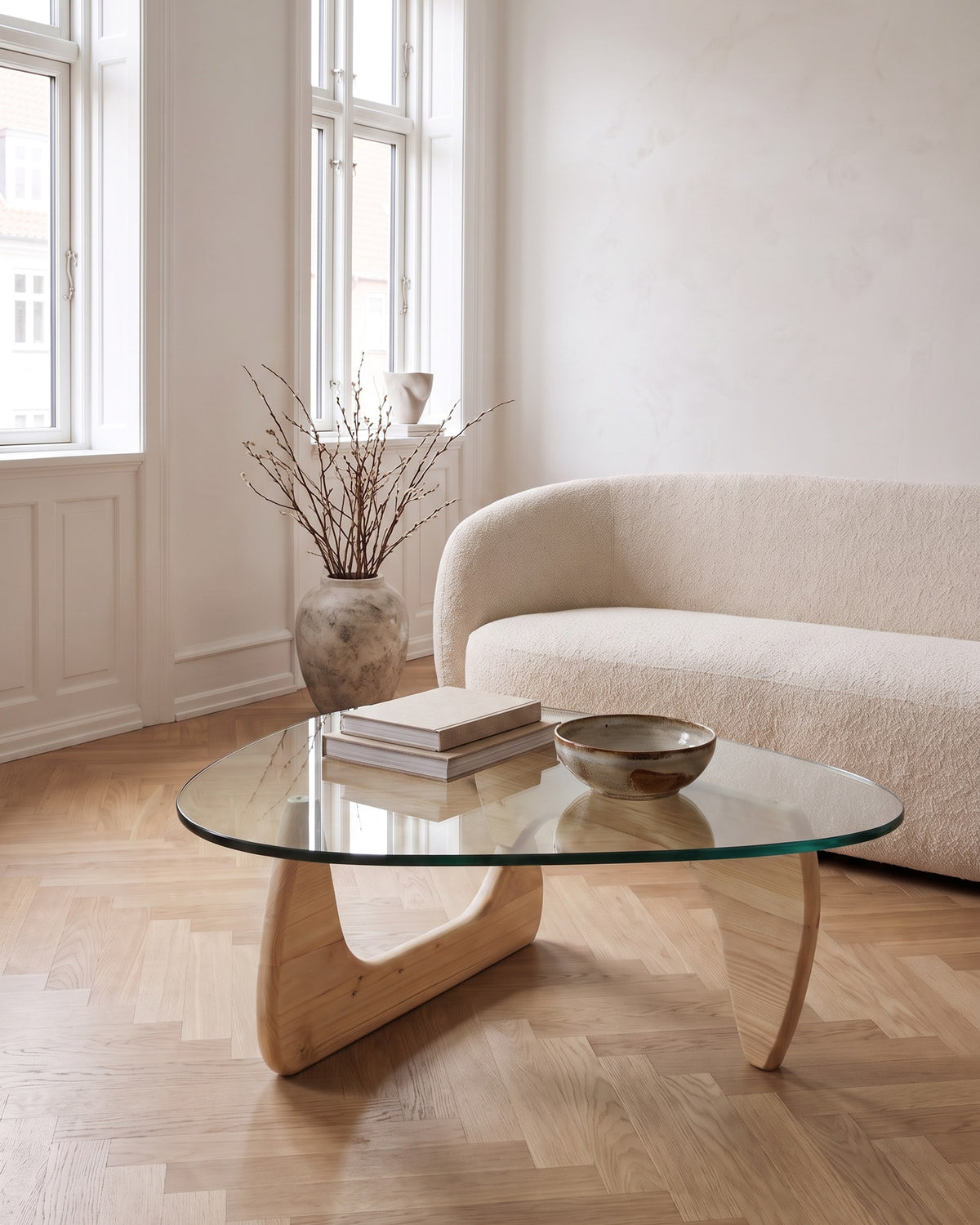 Elara coffee table in light oak with a drop-shaped glass top in a bright Scandinavian living room
