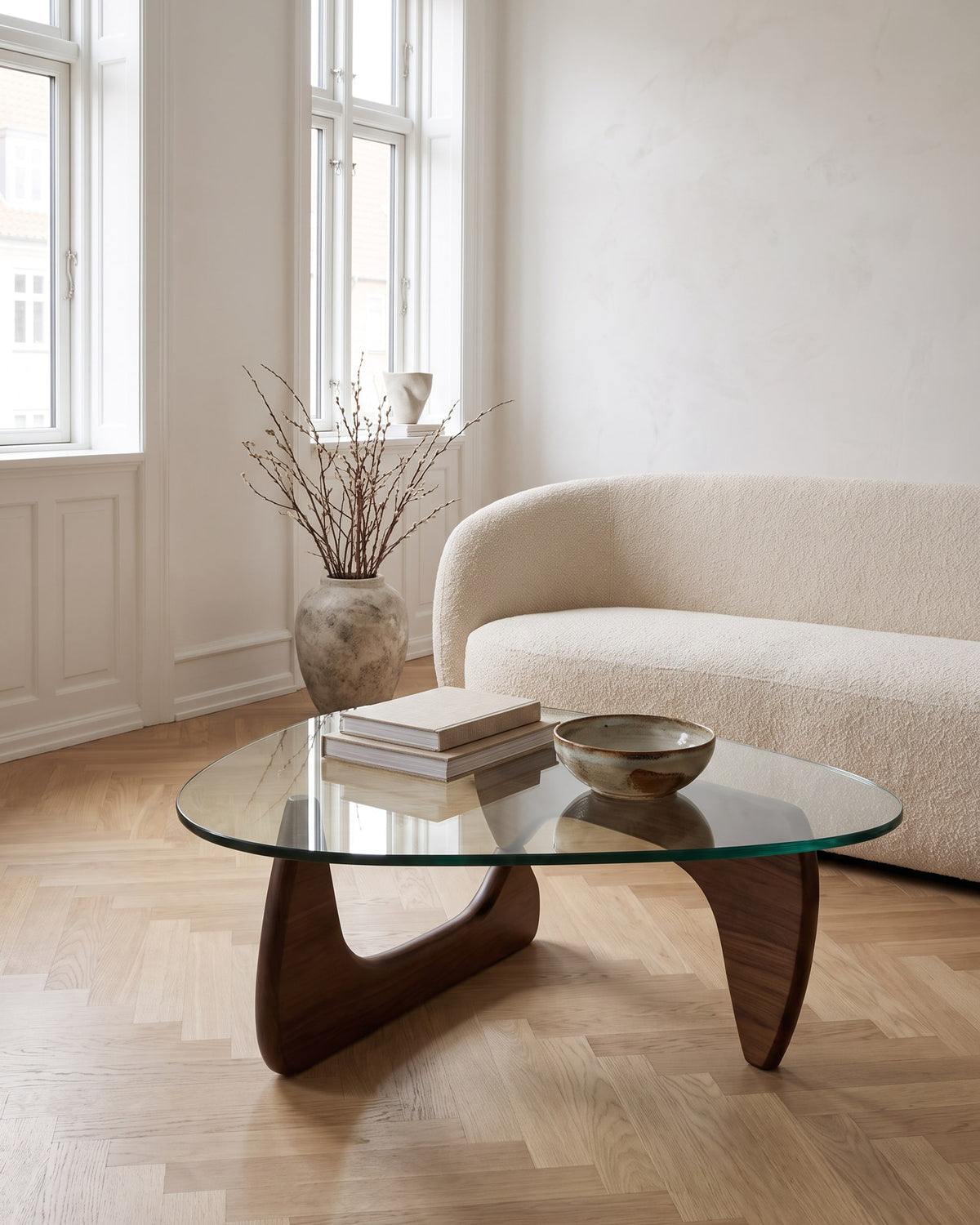 Elara coffee table in walnut with a drop-shaped glass top in a bright Scandinavian living room